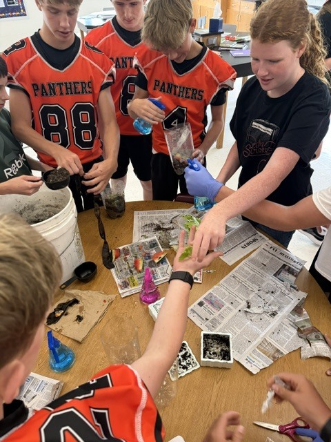 science students creating decomposition jars