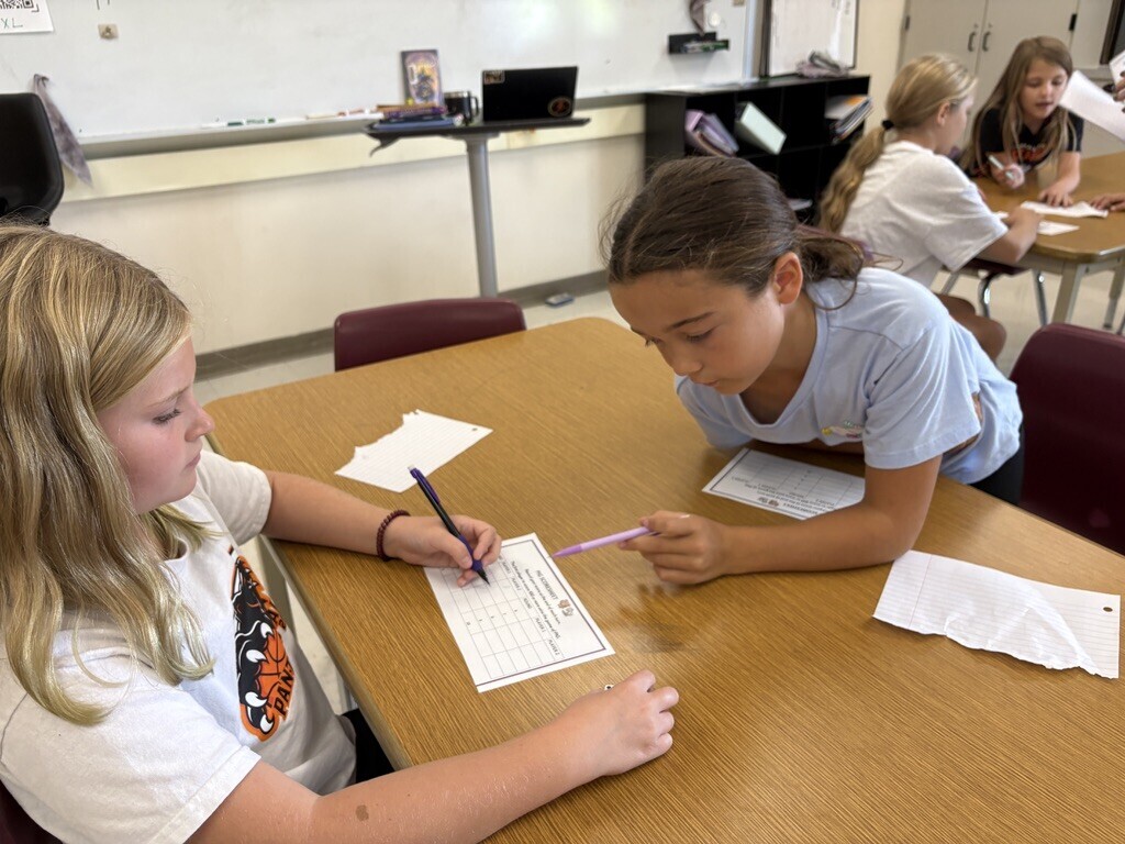 students playing dice game to work on math skills