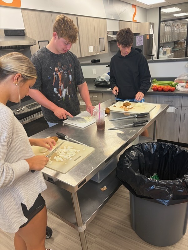 students demonstrating proper knife handling skills