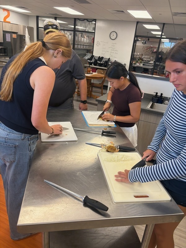 students demonstrating proper knife handling skills