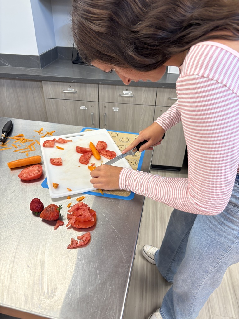 Foods class student making food creation with fruits and vegetables