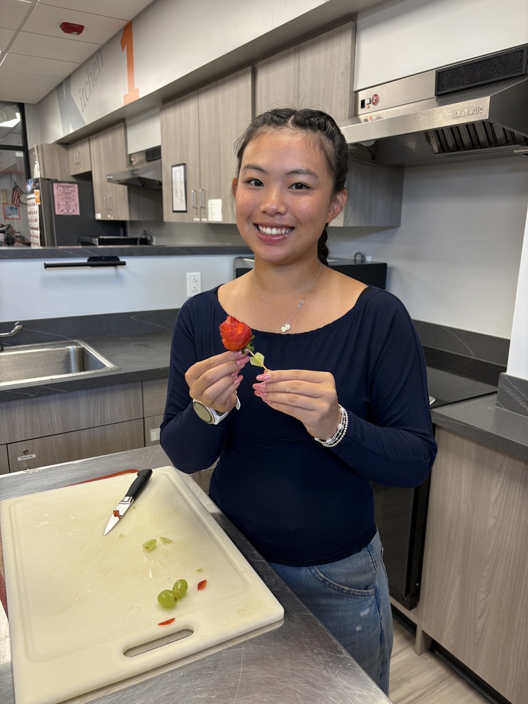 Foods class student making food creation with strawberry