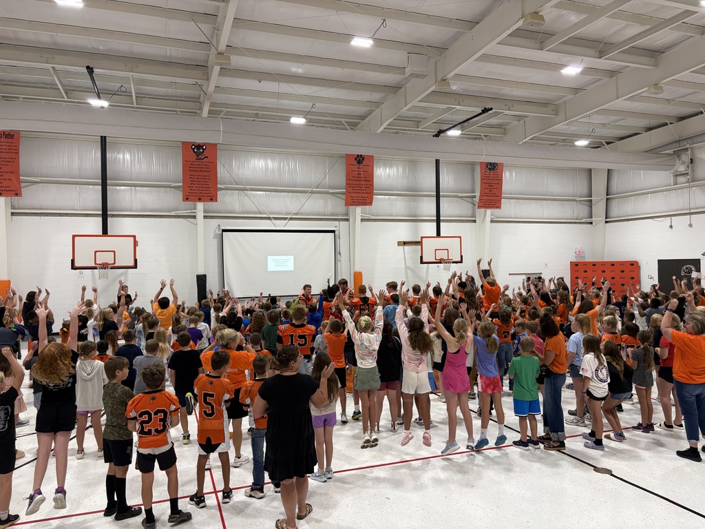 PHS Students during morning assembly in gym with students at PES