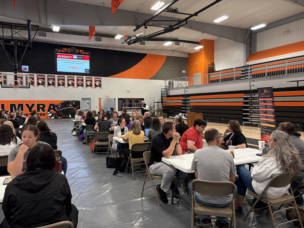 staff members in gym watching presentation