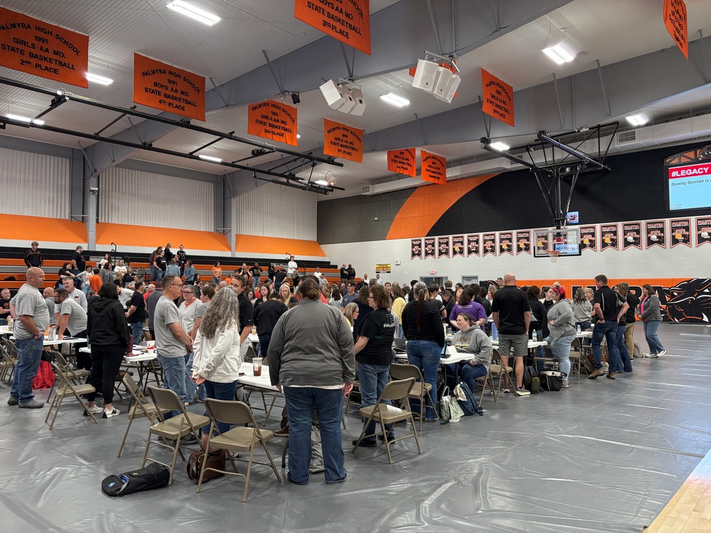 staff members in gym standing during presentation