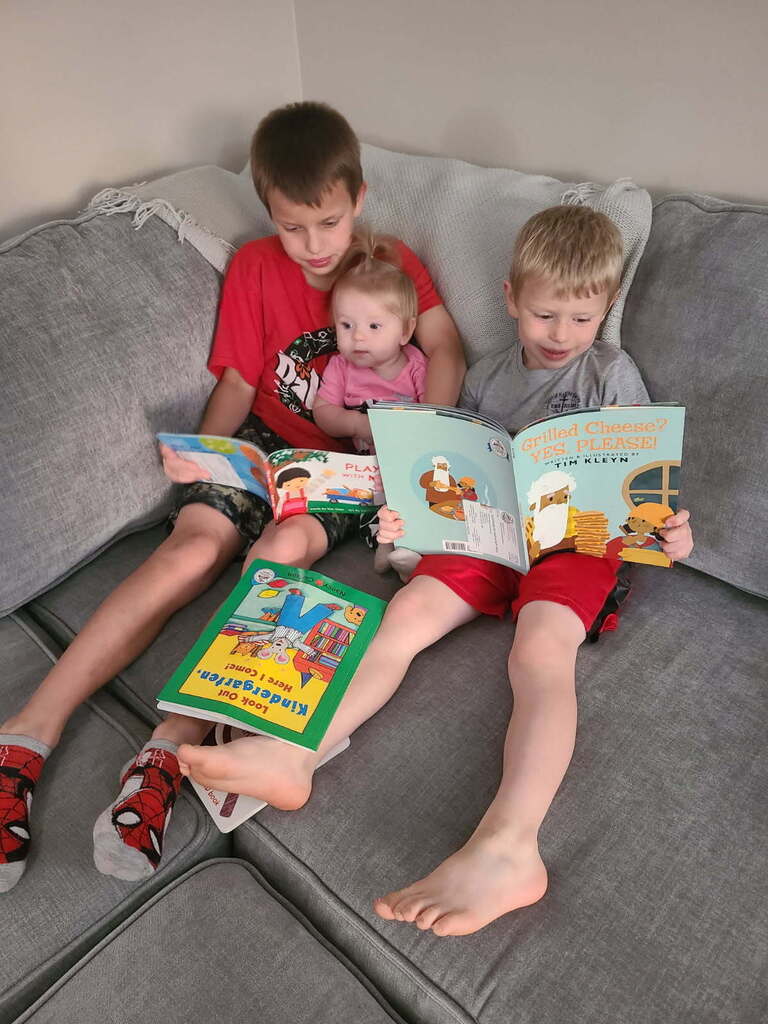 3 children reading books 