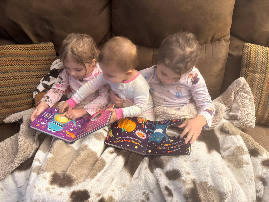 3 children reading books