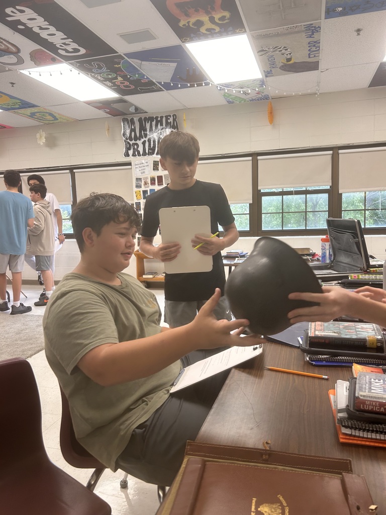 Student working on assignment related to WWII and looking at artifacts