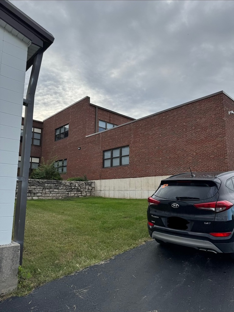 brick building with windows and grassy area