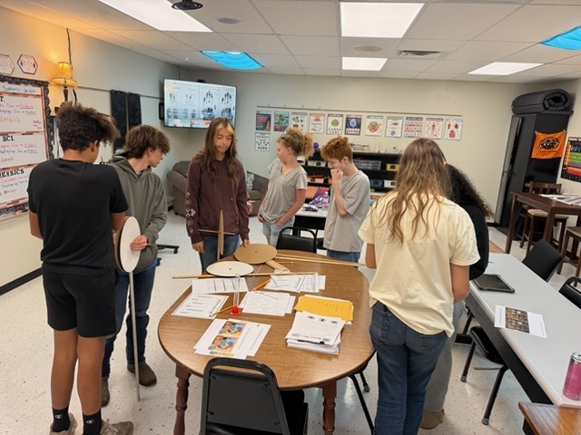 students making hodometers they made in class to measure distance