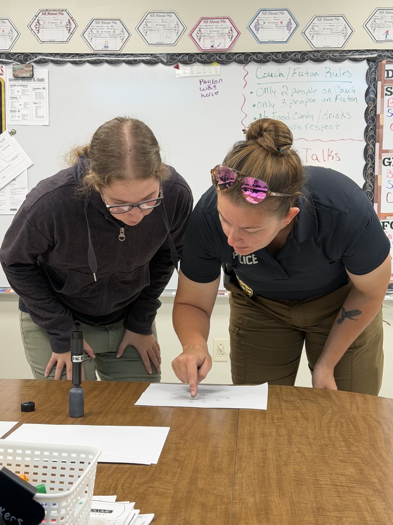 student and officer working on fingerprinting lesson