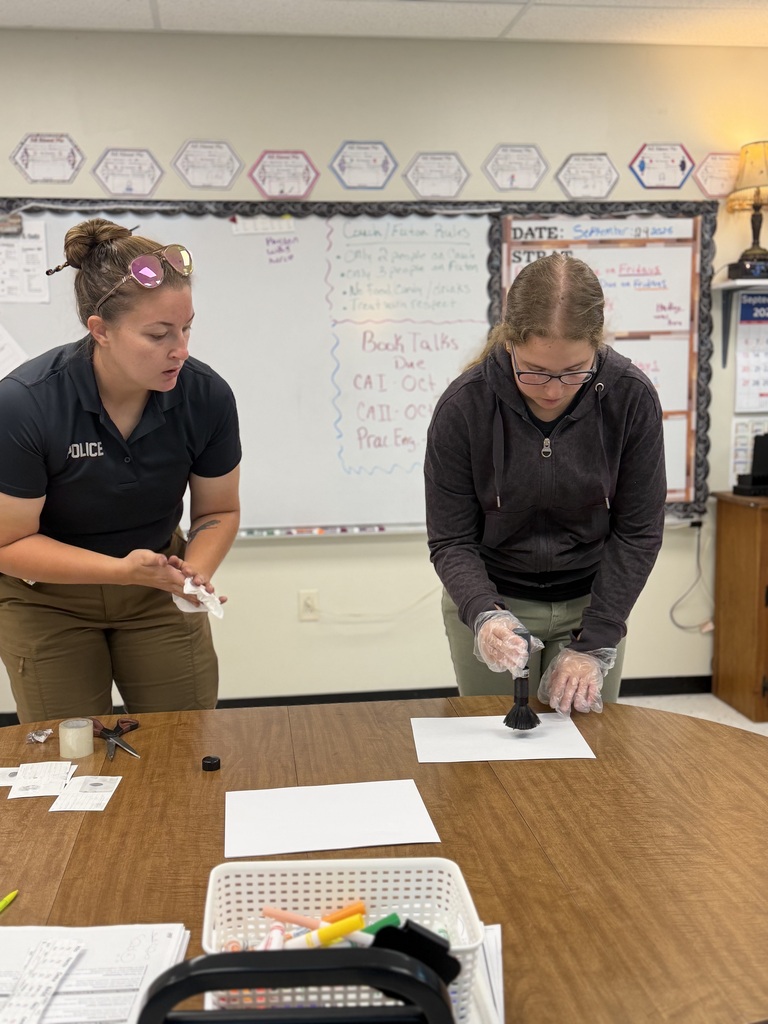 student and officer working on fingerprinting lesson