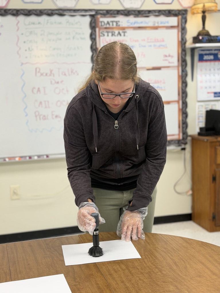 student and officer working on fingerprinting lesson