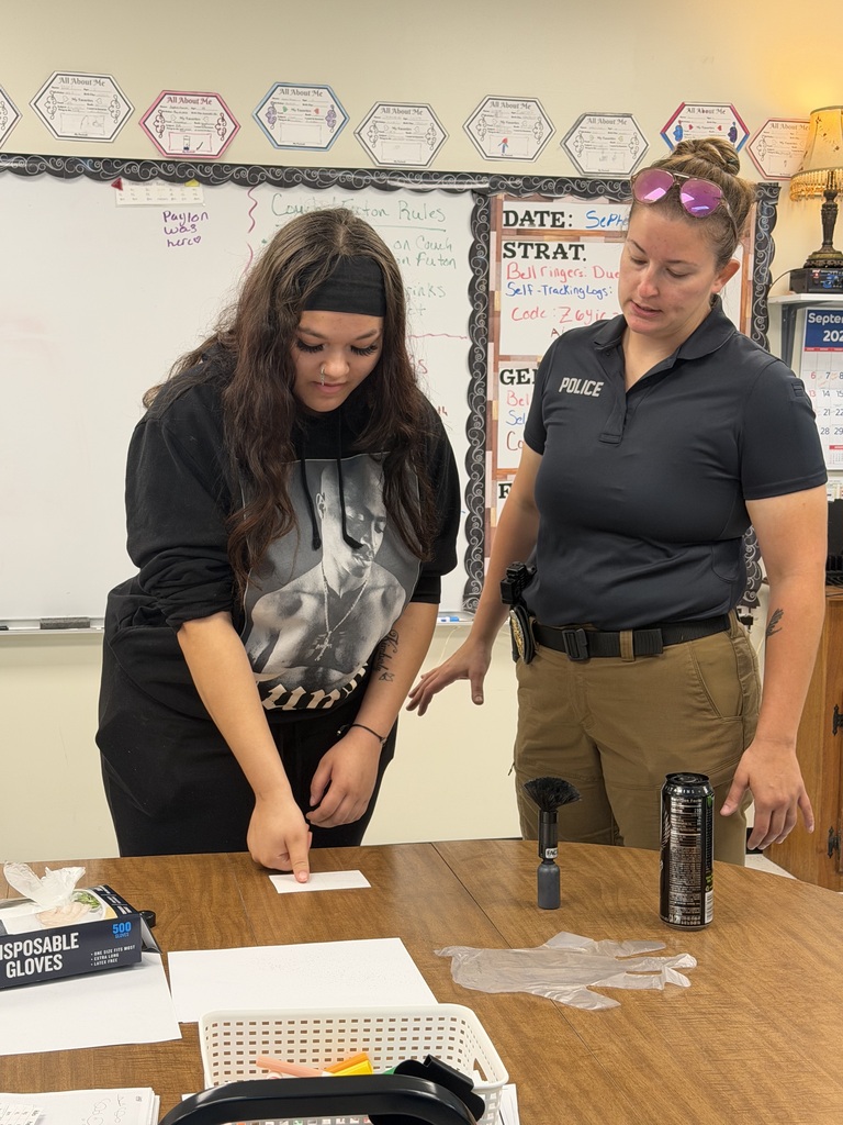 student and officer working on fingerprinting lesson