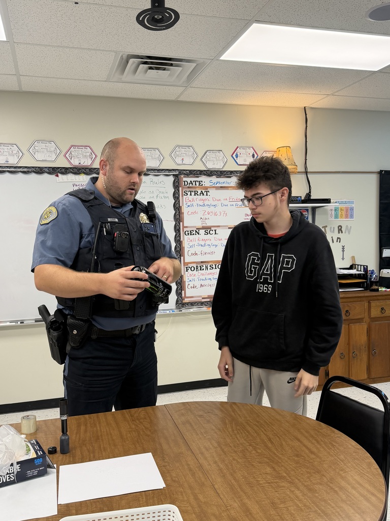 student and officer working on fingerprinting lesson