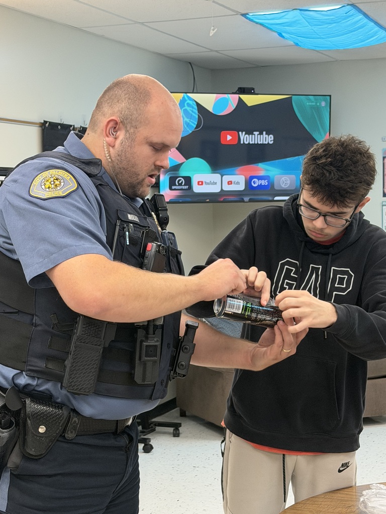 student and officer working on fingerprinting lesson on can
