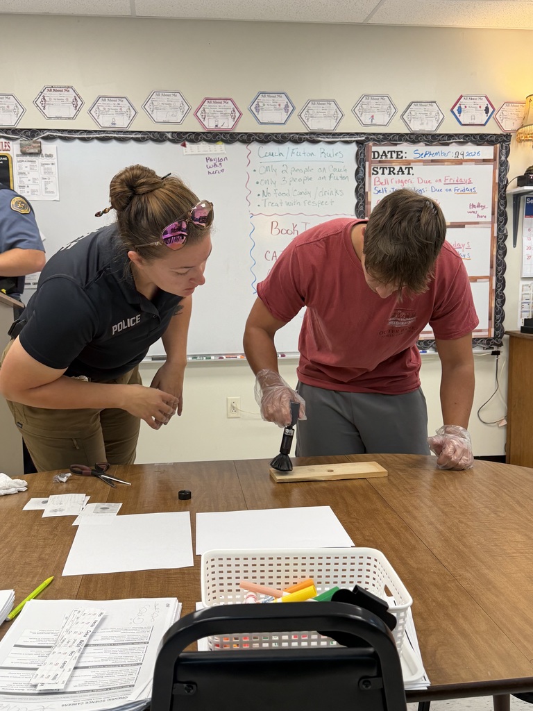 student and officer working on fingerprinting lesson