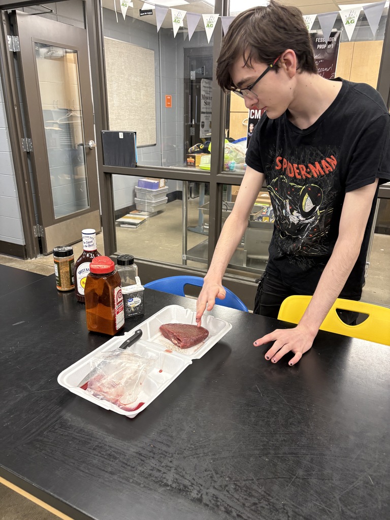 student marinating camel to cook on smoker
