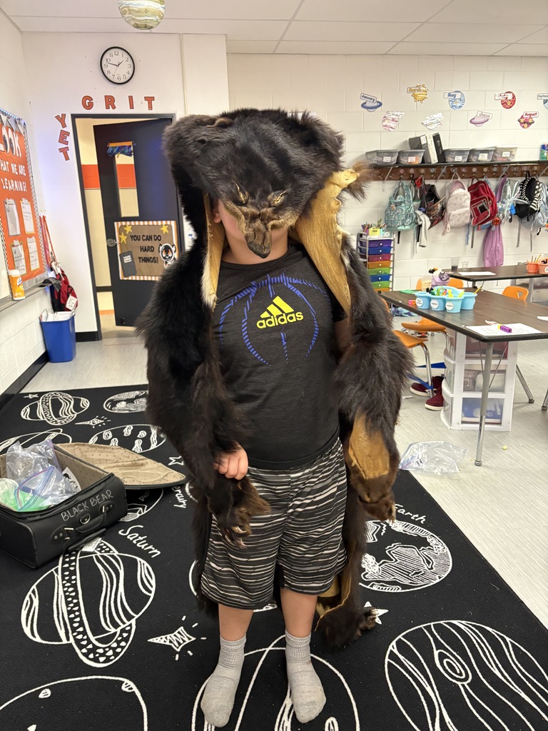 student with bear skin rug on his head