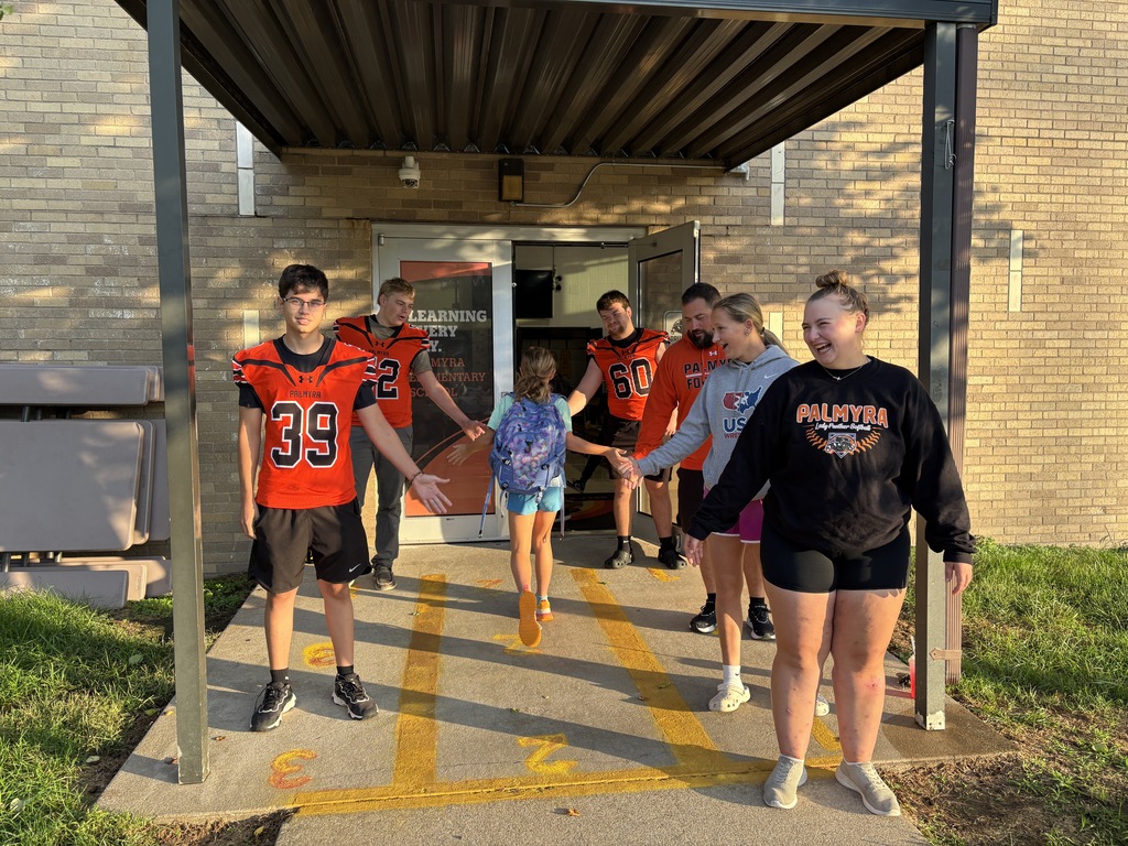 High School athletes greeting Elementary Students at car rider dropoff