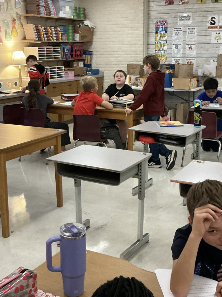 students working on science assignment in classroom