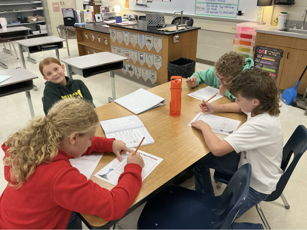students working on science assignment in classroom