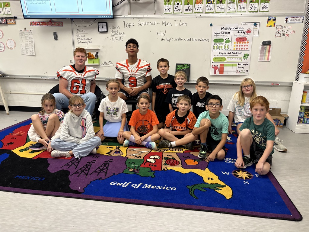 classroom students with 2 football players