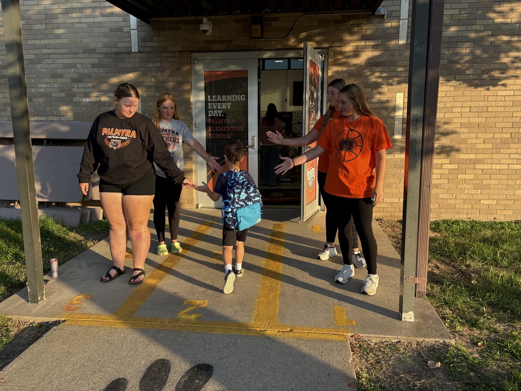 softball players greeting students at morning dropoff