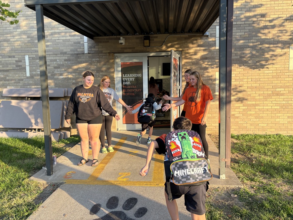 softball players greeting students at morning dropoff