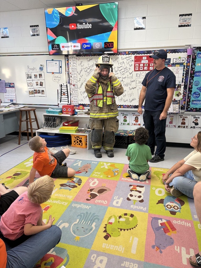 students dressed in fire gear