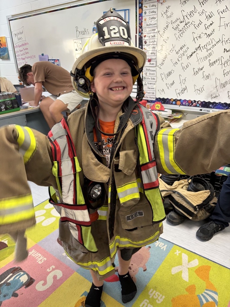 students dressed in fire gear