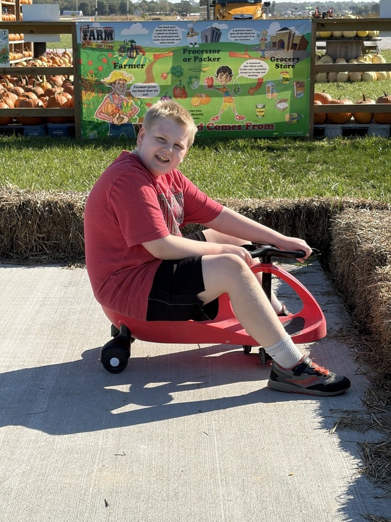 Student on scooter at pumpkin patch