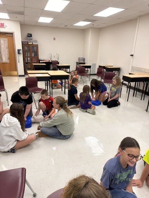 5th grade Health students practicing CPR and the Heimlich maneuver on dummies