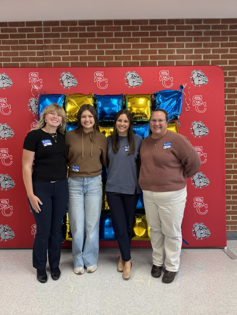 NHS Members and sponsor standing in front of display