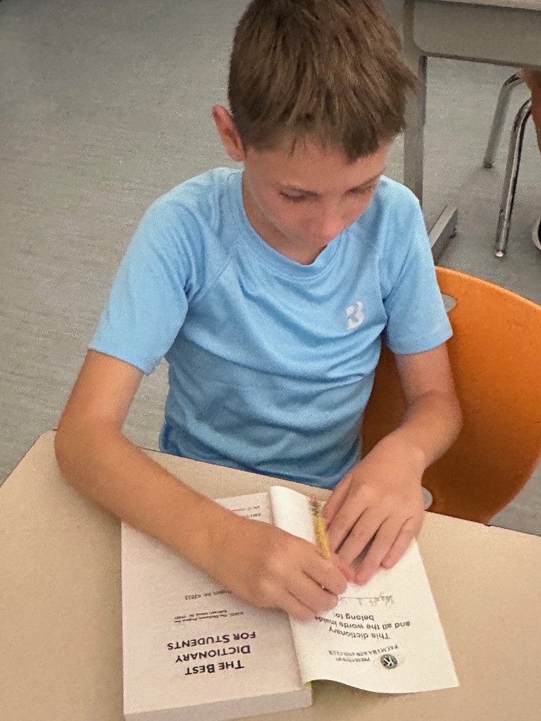 student using dictionary from Kiwanis club