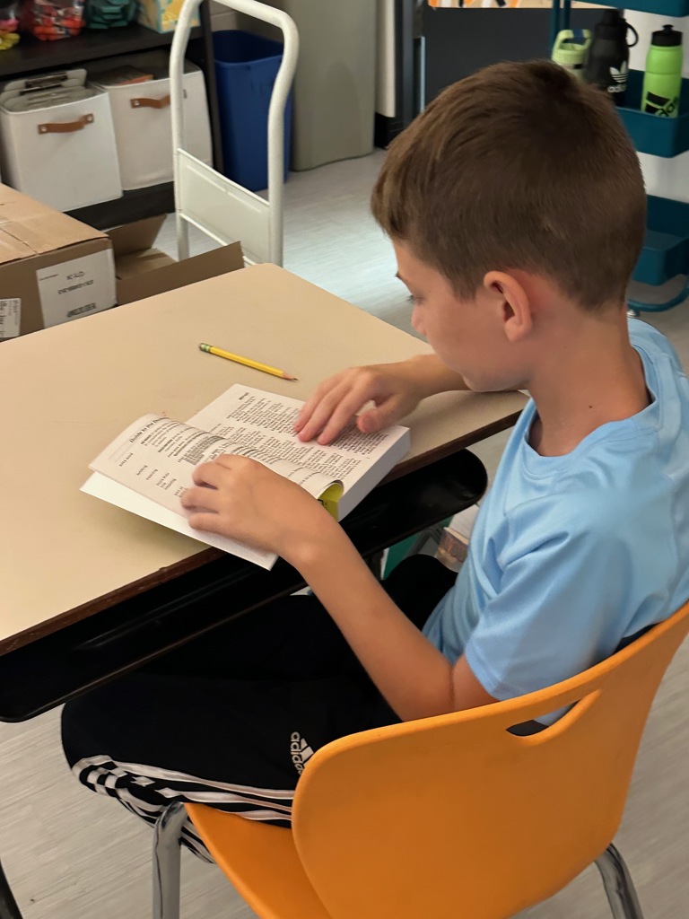 student using dictionary from Kiwanis club