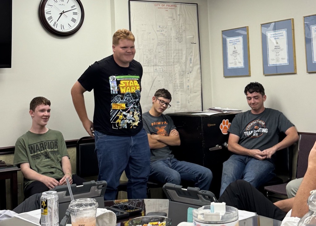 band members speaking at board meeting