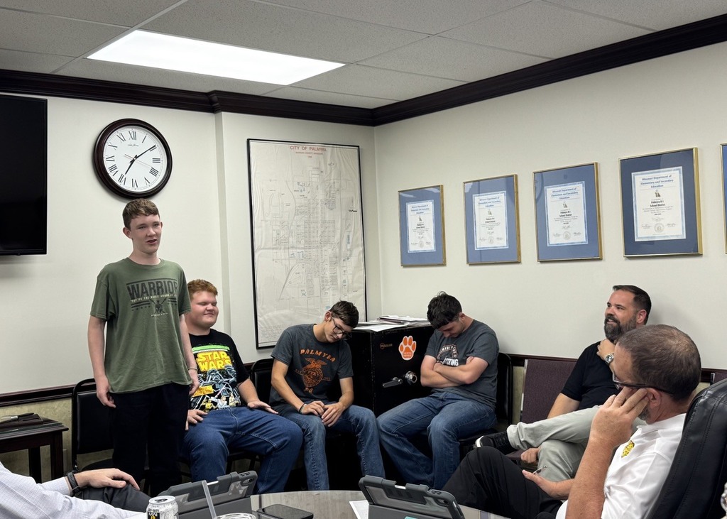 band members speaking at board meeting