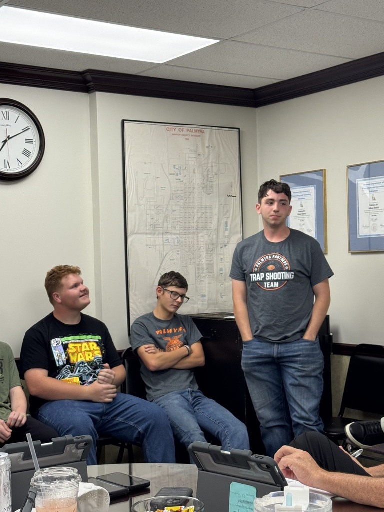 band members speaking at board meeting