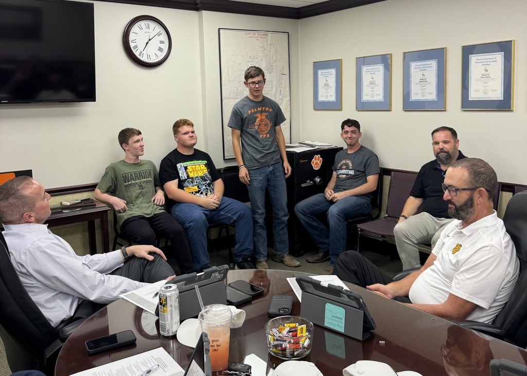 band members speaking at board meeting