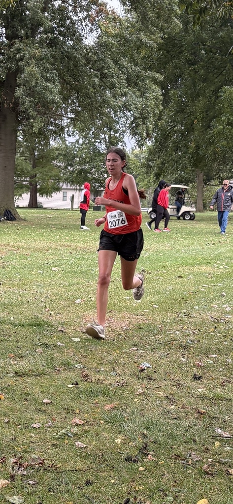 xc runner running towards finish line