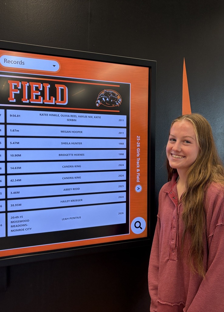 XC runner set new record standing by record board