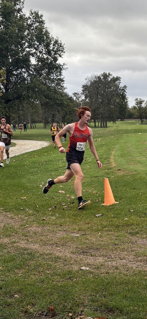 XC runner running around orange cone
