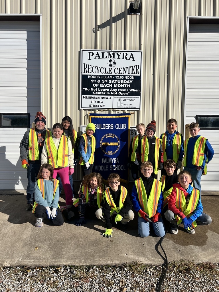 Middle school students posing outside of Recycle Center after working