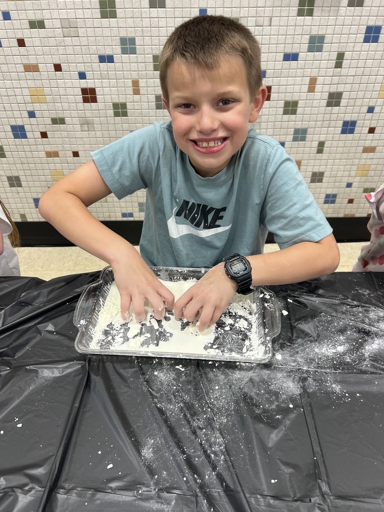 2nd grade students making oobleck in cafeteria