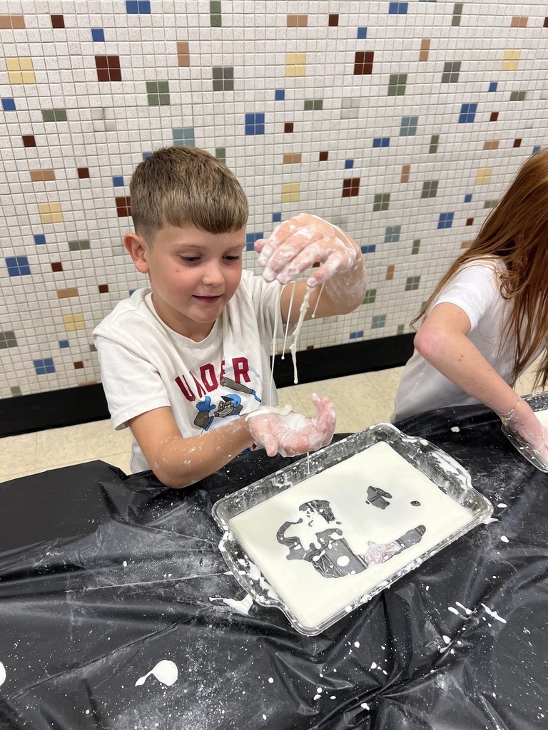 2nd grade students making oobleck in cafeteria