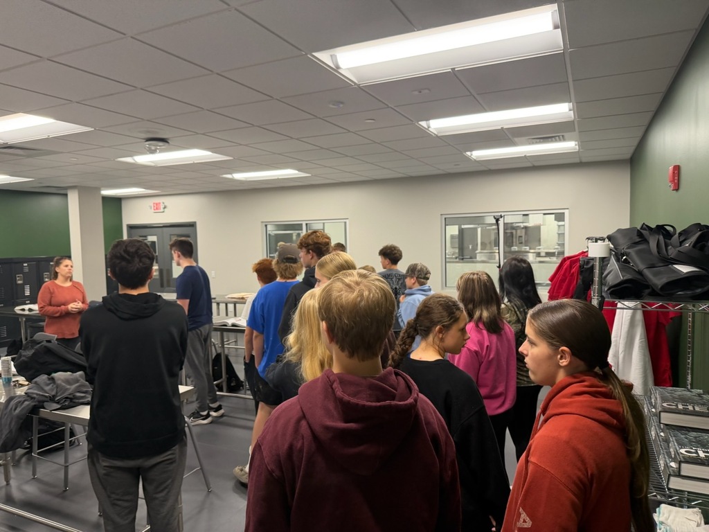 Middle School students listen to instructor speak on tour