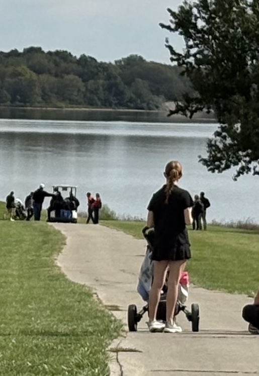 golfer and coach looking at hole