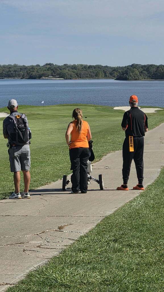 golfer and coach looking at hole