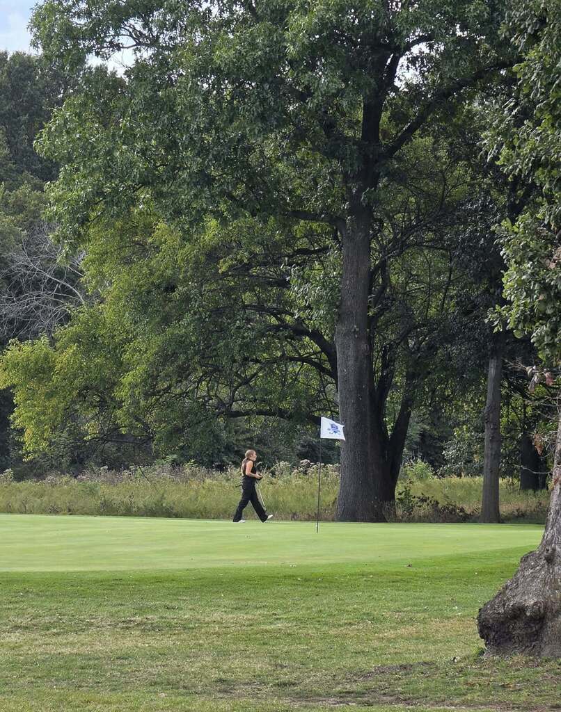 golfer walking on green